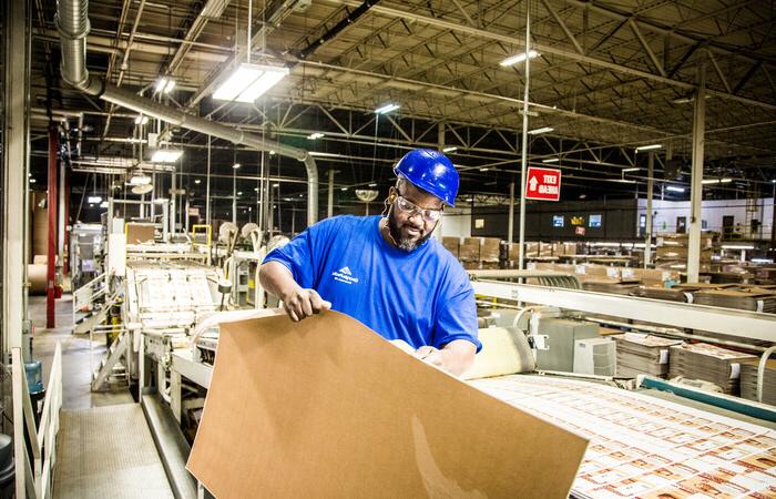 A man inspecting paper packaging